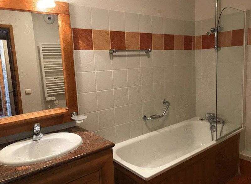 This bathroom features a classic design with a combination of functionality and style.