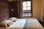 Cozy bedroom with a comfortable bed and inviting atmosphere.