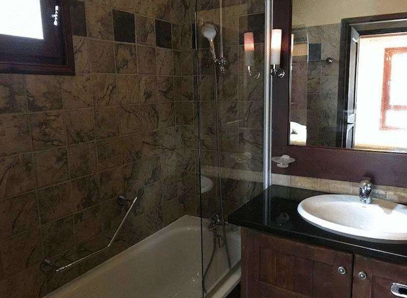 This bathroom features a sleek design with a modern vanity and a stylish sink.