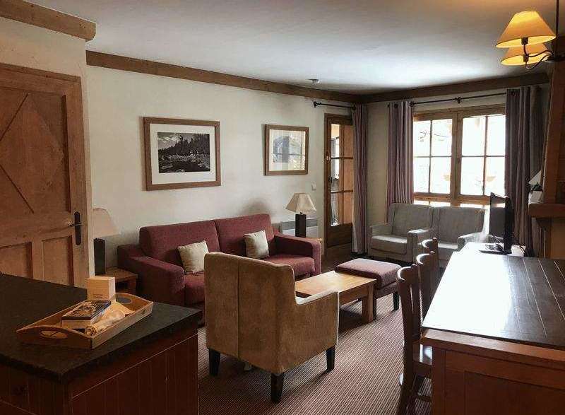 Cozy living space with a comfortable red sofa and inviting armchairs.