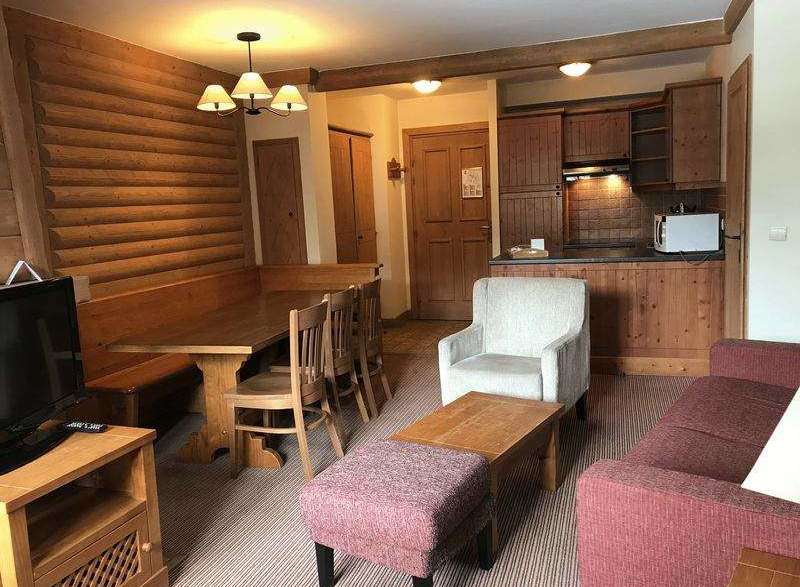 This cozy living space features a rustic wooden dining set, perfect for family meals.