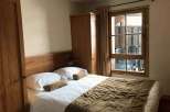 Cozy bedroom with a comfortable bed and a warm, inviting atmosphere.