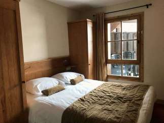 Cozy bedroom with a comfortable bed and a warm, inviting atmosphere.