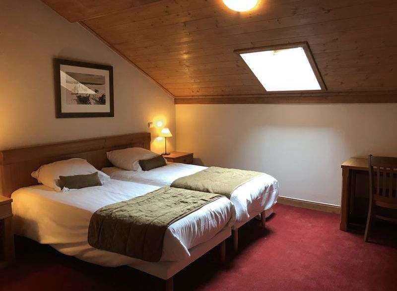 Cozy bedroom with two twin beds, perfect for a comfortable stay.