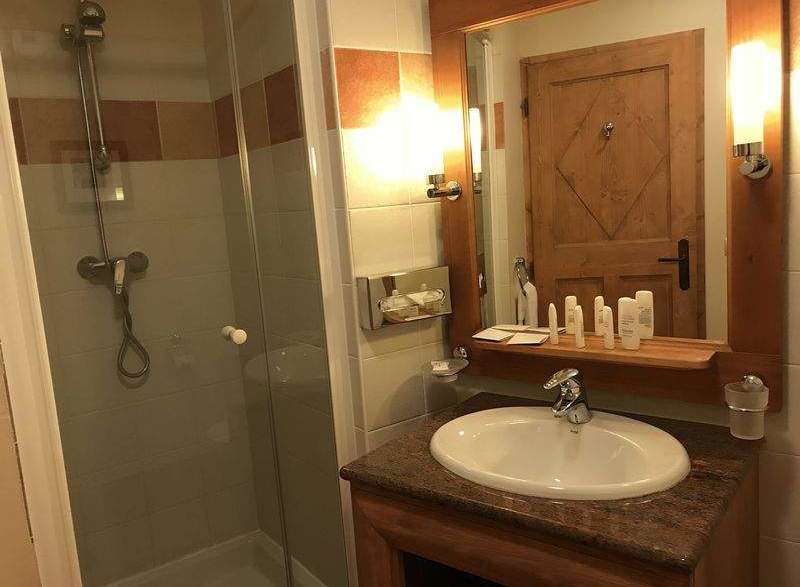 This cozy bathroom features a modern shower and a stylish sink area.
