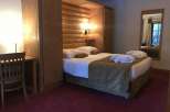 Cozy and inviting hotel room featuring a comfortable bed with plush bedding and a warm, inviting atmosphere.