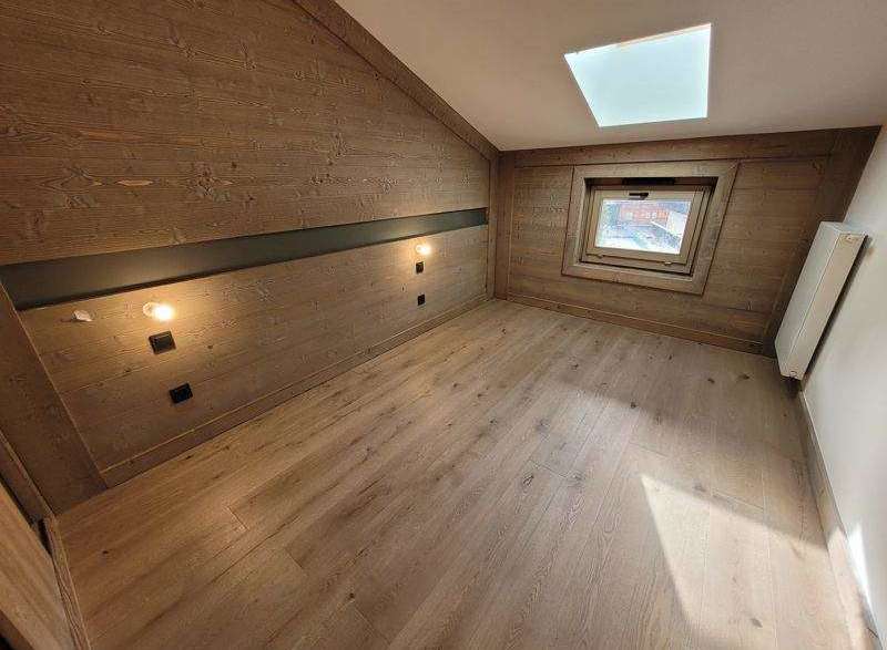 Discover the charm of this cozy room, featuring stunning wooden paneling that adds warmth and character.