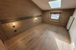 Discover the charm of this cozy room, featuring stunning wooden paneling that adds warmth and character.