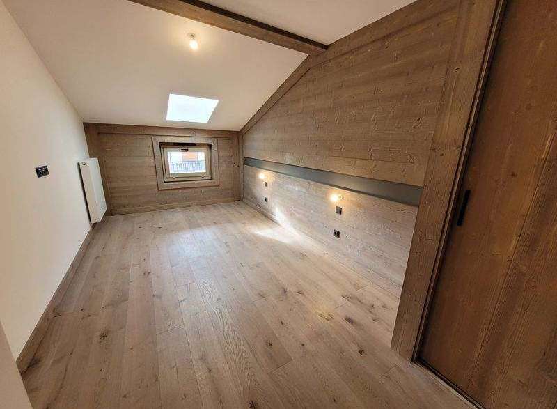Discover the charm of this cozy room, featuring beautiful wooden walls and flooring that exude warmth and character.