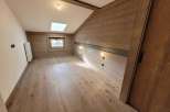 Discover the charm of this cozy room, featuring beautiful wooden walls and flooring that exude warmth and character.
