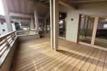 This stunning property boasts a spacious wooden deck, perfect for outdoor relaxation and entertainment.
