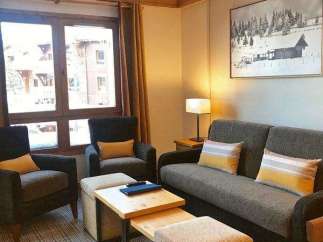 Cozy living room with comfortable seating and a charming ambiance.