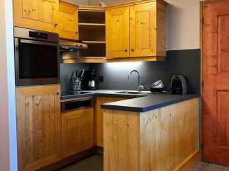 This charming kitchen features warm wooden cabinetry, creating a cozy and inviting atmosphere.
