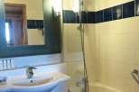 This bathroom features a stylish design with a modern sink and a sleek shower setup.