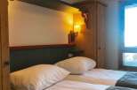 Cozy bedroom with twin beds, perfect for a relaxing stay.
