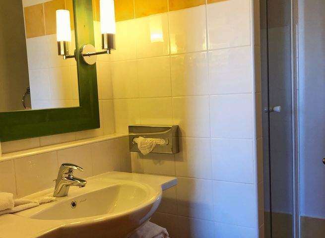 This charming bathroom features a stylish sink and a modern shower.