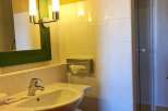 This charming bathroom features a stylish sink and a modern shower.