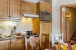 This charming kitchen features warm wooden cabinetry and a cozy atmosphere.