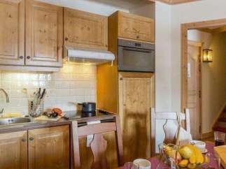 This charming kitchen features warm wooden cabinetry and a cozy atmosphere.