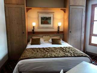 Cozy bedroom with a comfortable bed and warm lighting.