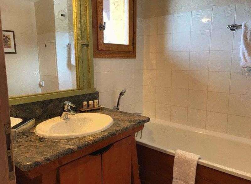 This charming bathroom features a classic design with a touch of rustic elegance.