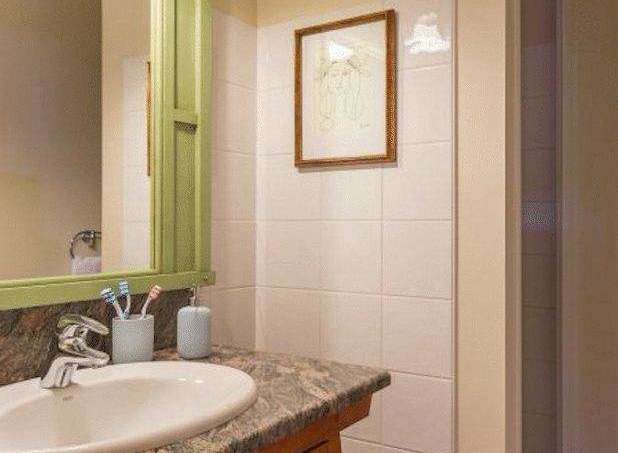 This bathroom features a stylish vanity with a granite countertop and a sleek sink.