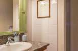 This bathroom features a stylish vanity with a granite countertop and a sleek sink.