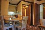 Cozy kitchen with a round dining table and chairs, perfect for enjoying meals.