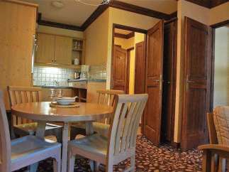 Cozy kitchen with a round dining table and chairs, perfect for enjoying meals.