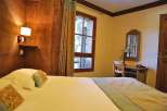 Cozy bedroom with wooden accents and a comfortable bed.