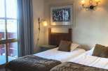 Cozy bedroom featuring two twin beds, perfect for a comfortable stay.