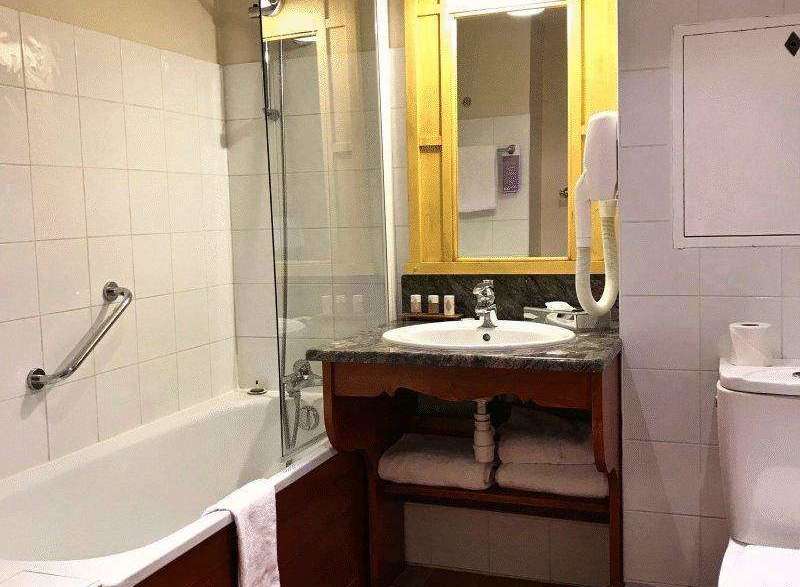 This bathroom features a classic design with a bathtub and a separate shower area.