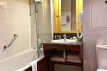This bathroom features a classic design with a bathtub and a separate shower area.