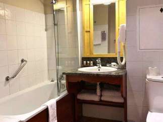 This bathroom features a classic design with a bathtub and a separate shower area.