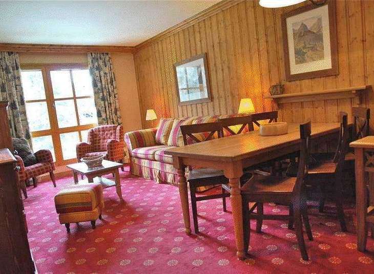 This cozy living space features a charming wooden interior, creating a warm and inviting atmosphere.