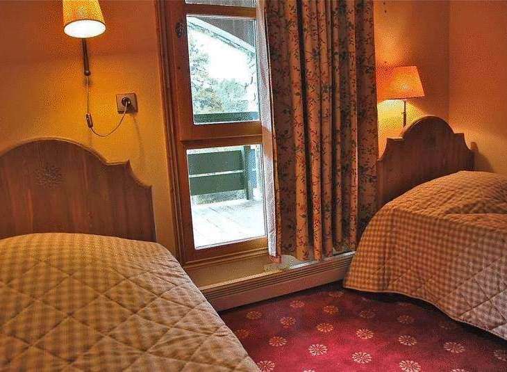 Cozy bedroom with two twin beds, perfect for a comfortable stay.