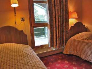 Cozy bedroom with two twin beds, perfect for a comfortable stay.