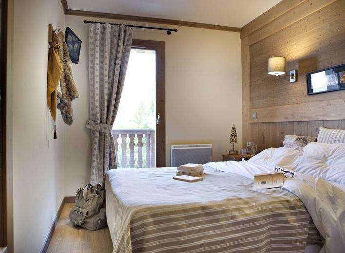 Cozy bedroom with a balcony, perfect for a relaxing getaway.