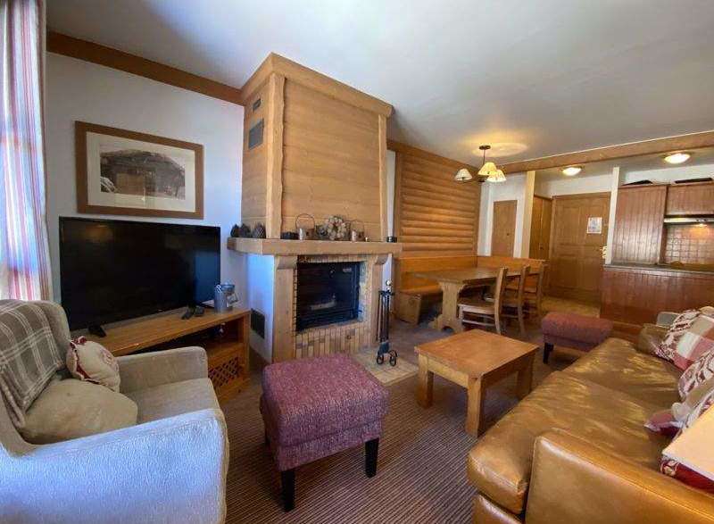 Cozy up in this charming living space, complete with a rustic fireplace and inviting seating.