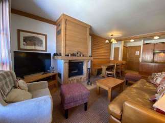 Cozy up in this charming living space, complete with a rustic fireplace and inviting seating.