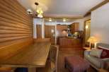 Cozy apartment with a rustic charm, featuring a wooden dining area and a fully equipped kitchen.