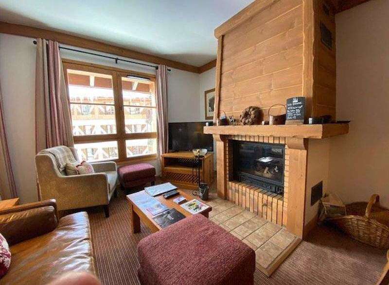 Cozy up in this charming living space, complete with a rustic fireplace and inviting ambiance.