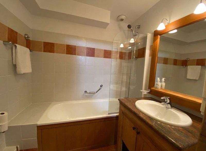 This bathroom features a classic design with a bathtub and a separate shower area.