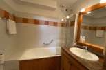 This bathroom features a classic design with a bathtub and a separate shower area.