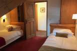 Cozy bedroom with two single beds, perfect for a comfortable stay.