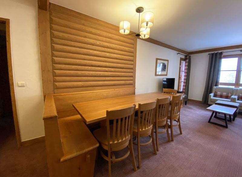 This cozy dining area features a beautiful wooden table and chairs, perfect for enjoying meals with family and friends.