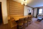 This cozy dining area features a beautiful wooden table and chairs, perfect for enjoying meals with family and friends.
