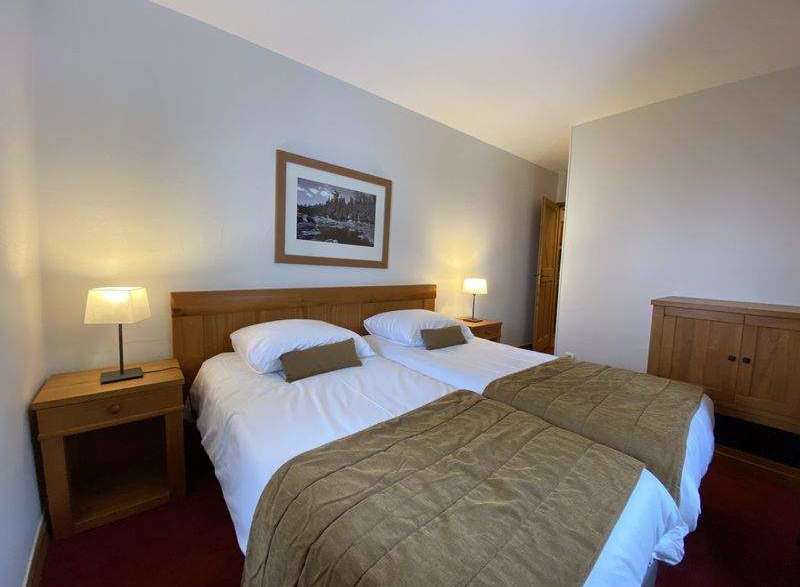 This cozy bedroom features two comfortable beds, perfect for a relaxing stay.