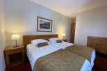This cozy bedroom features two comfortable beds, perfect for a relaxing stay.