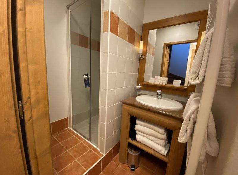 This cozy bathroom features a glass shower, perfect for a refreshing start to your day.